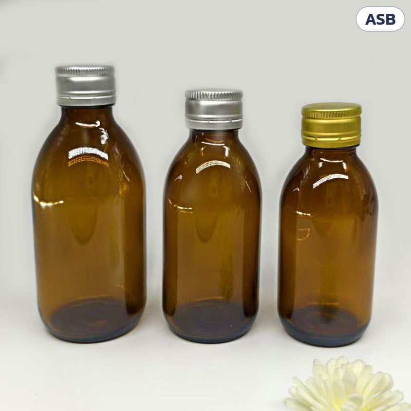 ขวดยาน้ำแก้วสีชา ฝาเกลียว ASB – ขวดยาน้ำแก้วสีชา สามใบ สวมฝาอะลูมิเนียมสีเงินและสีทอง